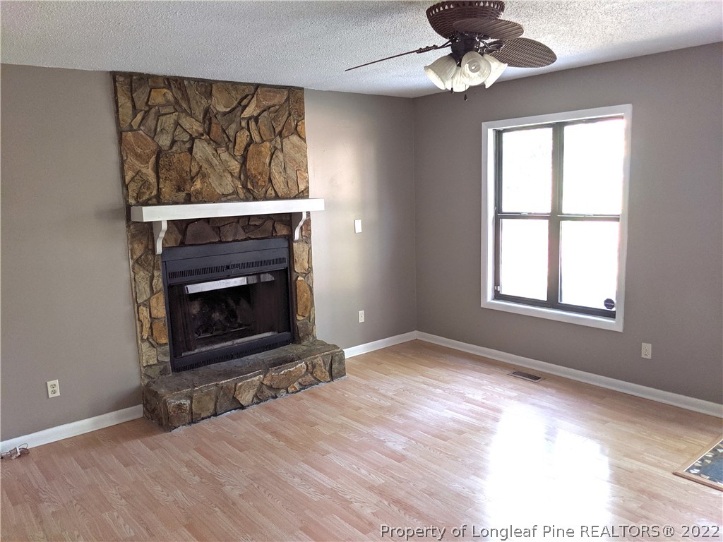 6653 Vaughn Road Fayetteville, NC 28304 - Photo 2 of 7 a view of empty room with a fireplace