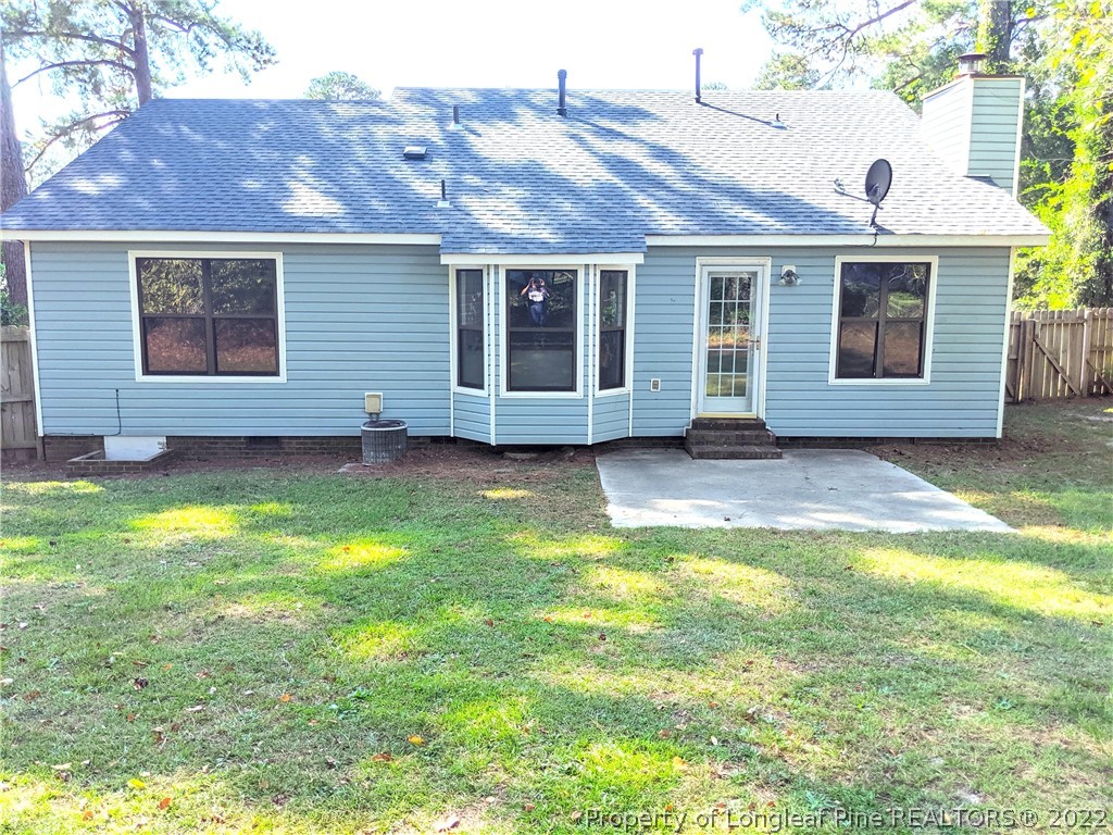 6653 Vaughn Road Fayetteville, NC 28304 - Photo 5 of 7 a view of a house with a garden and yard
