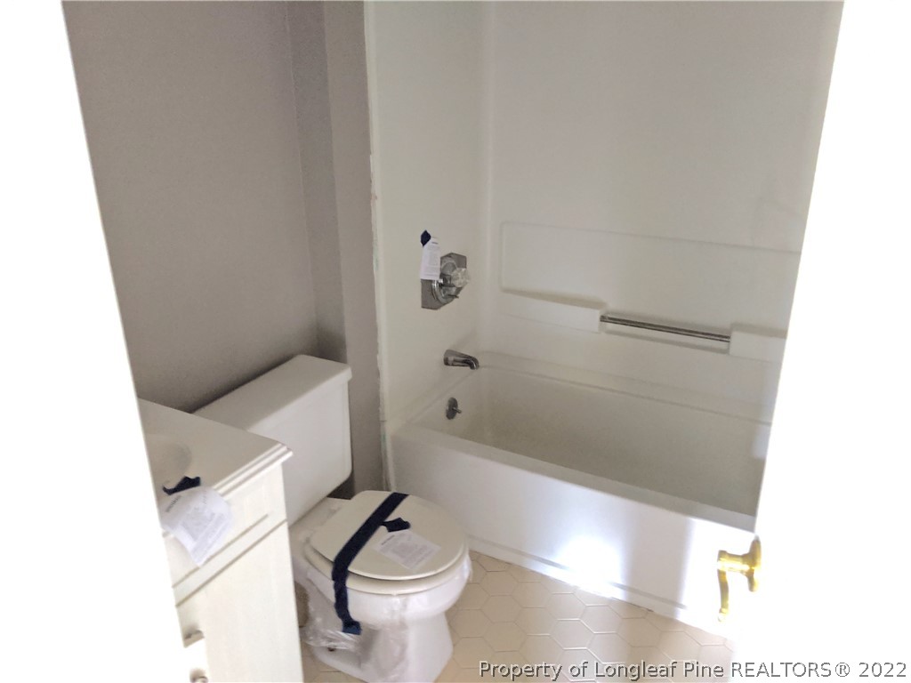 6653 Vaughn Road Fayetteville, NC 28304 - Photo 6 of 7 a bathroom with a bathtub and a toilet