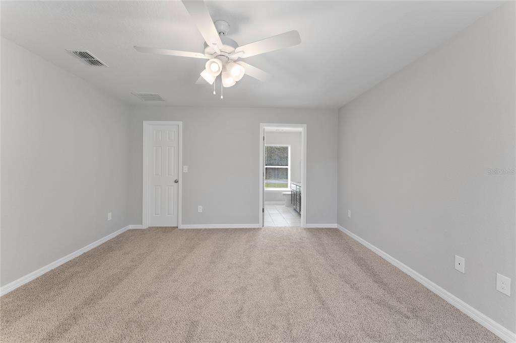 9461 North Sandree Drive Citrus Springs, FL 34434 - Photo 18 of 50 a view of an empty room with a fan
