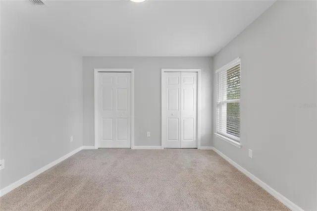 a view of an empty room and a window