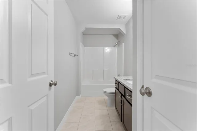 a bathroom with a sink a toilet a mirror and shower