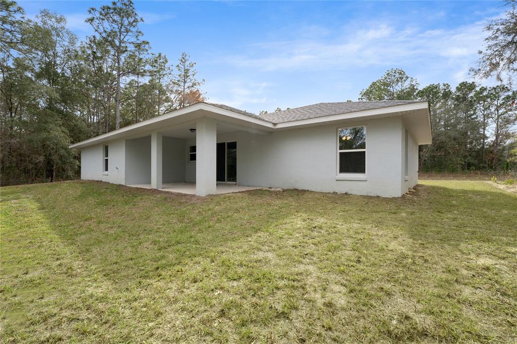 9461 North Sandree Drive Citrus Springs, FL 34434 - Photo 41 of 50 a view of a house with a yard