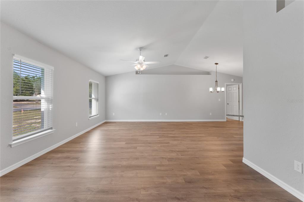 9461 North Sandree Drive Citrus Springs, FL 34434 - Photo 7 of 50 a view of an empty room with wooden floor and a window