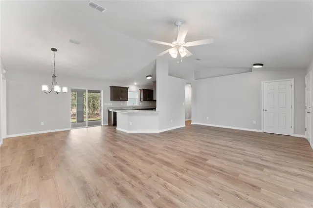a view of a livingroom with a dishwasher cabinets and wooden floor