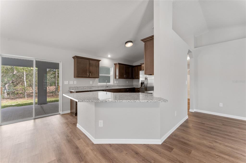 9461 North Sandree Drive Citrus Springs, FL 34434 - Photo 10 of 50 a large white kitchen with a large window a sink and a counter top space
