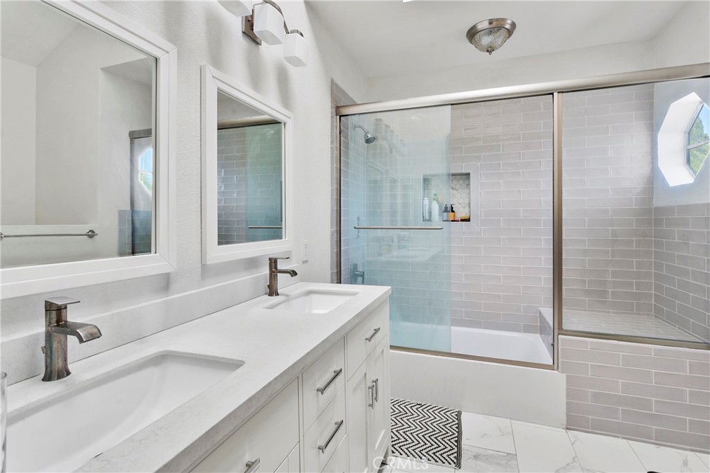 2575 Elden Avenue, Unit 2 Costa Mesa, CA 92627 - Photo 6 of 12 a bathroom with a shower sink and mirror