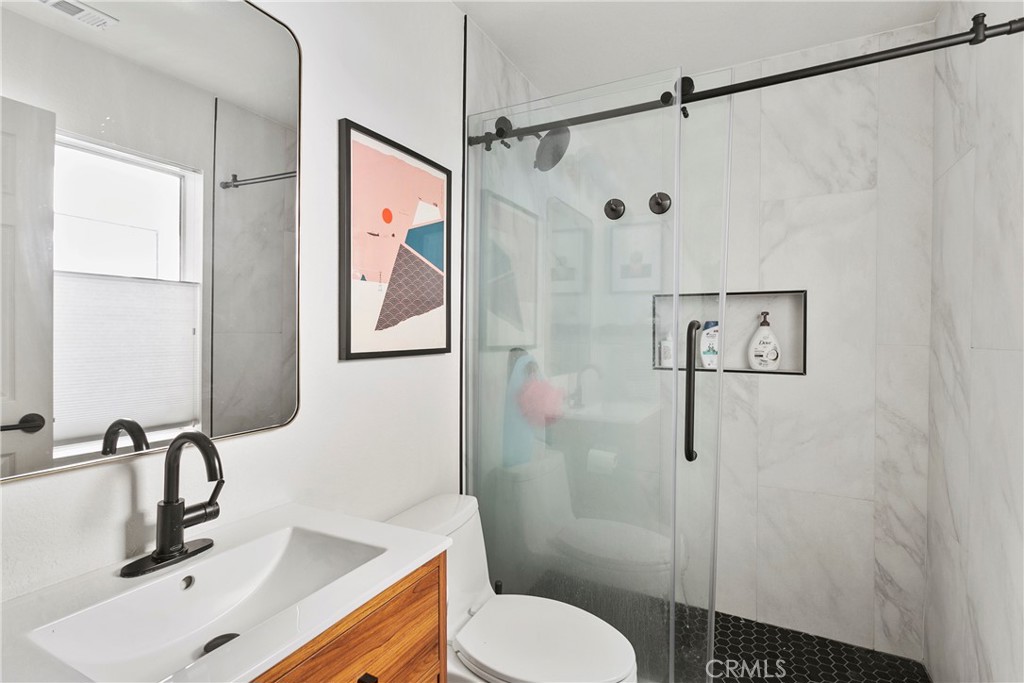 2575 Elden Avenue, Unit 2 Costa Mesa, CA 92627 - Photo 8 of 12 a bathroom with a sink toilet and shower