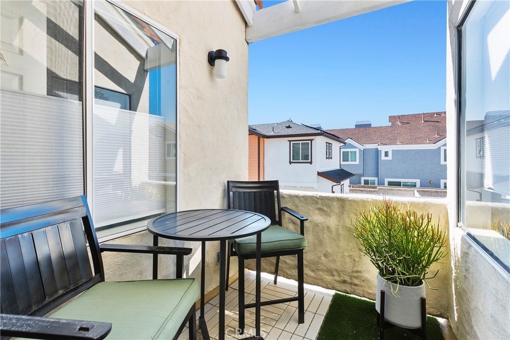 2575 Elden Avenue, Unit 2 Costa Mesa, CA 92627 - Photo 10 of 12 a view of a balcony with table and chairs