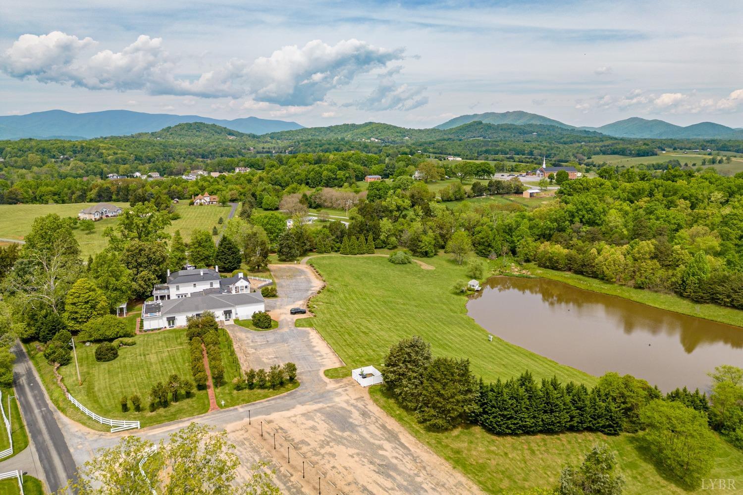 7821 Bellevue Road Goode, VA 24556 - Photo 16 of 78 an aerial view of residential houses with outdoor space and lake view
