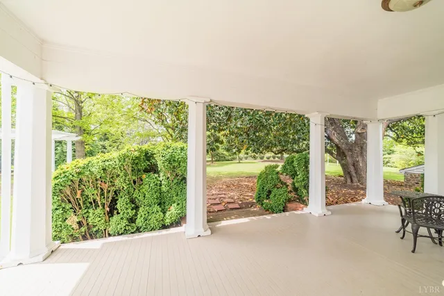 a large kitchen with kitchen island a chandelier and living room
