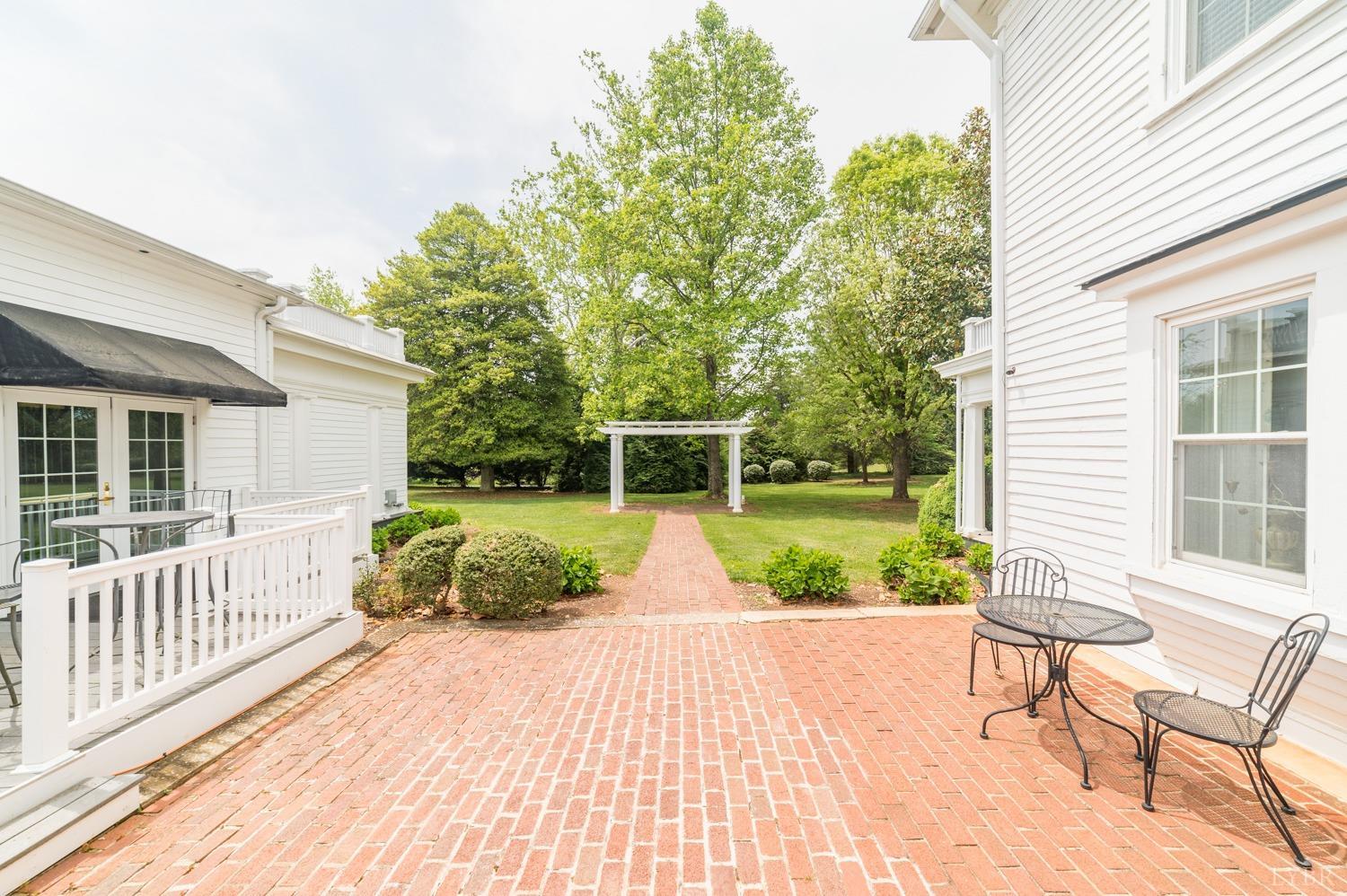 7821 Bellevue Road Goode, VA 24556 - Photo 28 of 78 a front view of a house with a yard and potted plants