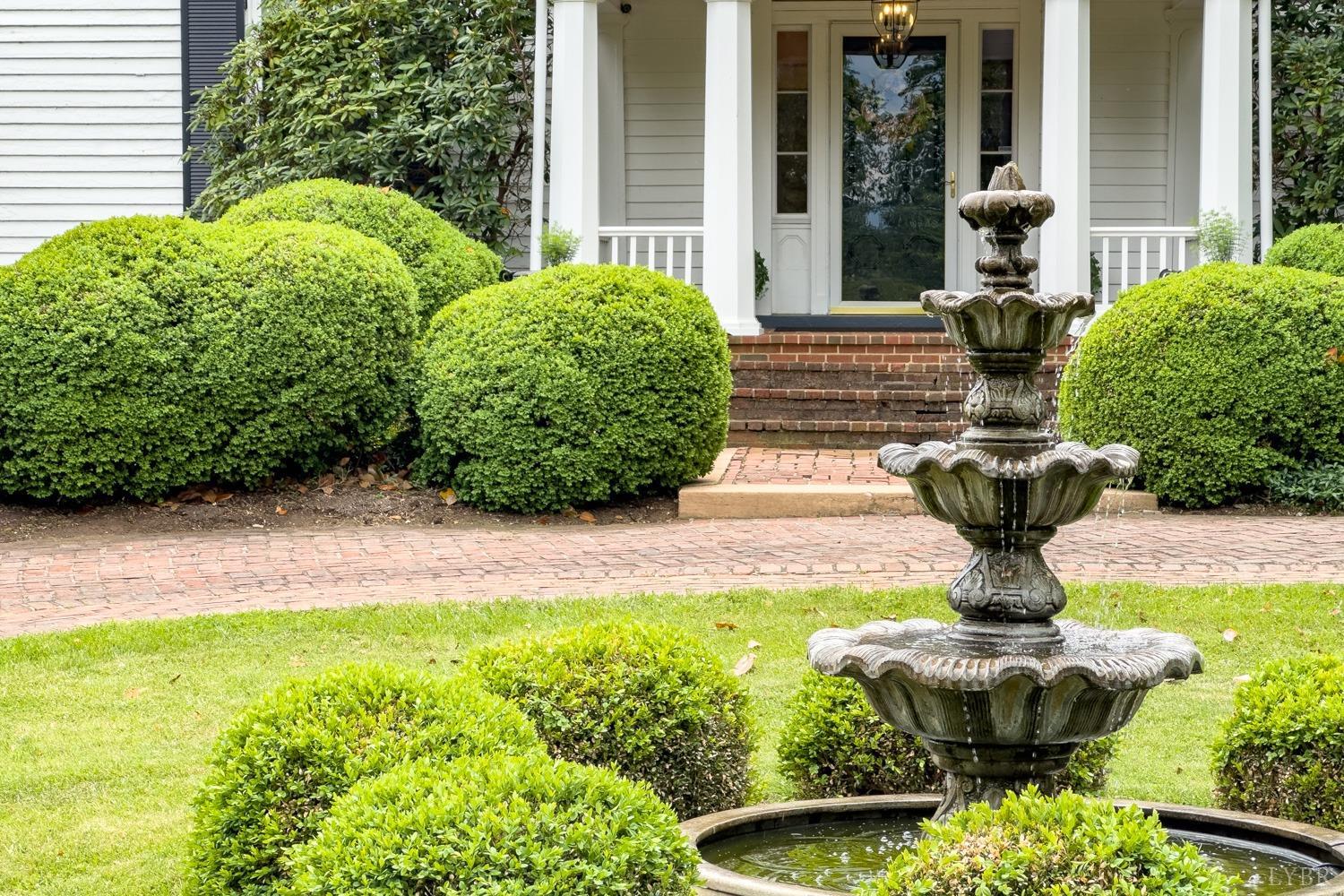 7821 Bellevue Road Goode, VA 24556 - Photo 37 of 78 a view of a fountain in the yard next to a house