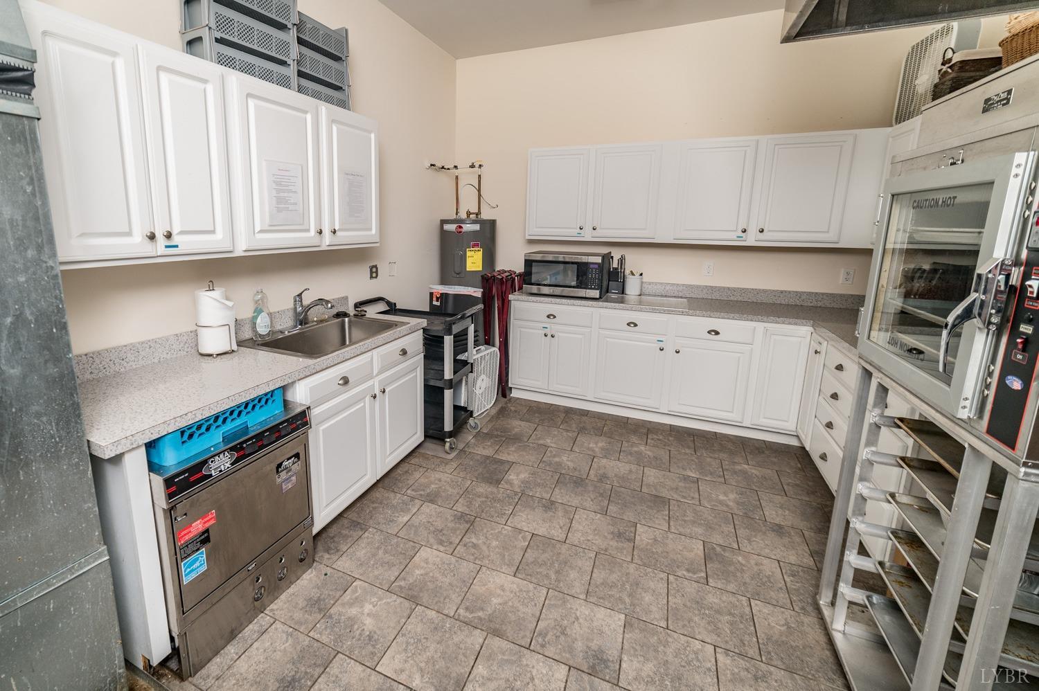 7821 Bellevue Road Goode, VA 24556 - Photo 44 of 78 a kitchen with stainless steel appliances a sink a stove a microwave a sink a refrigerator and cabinets