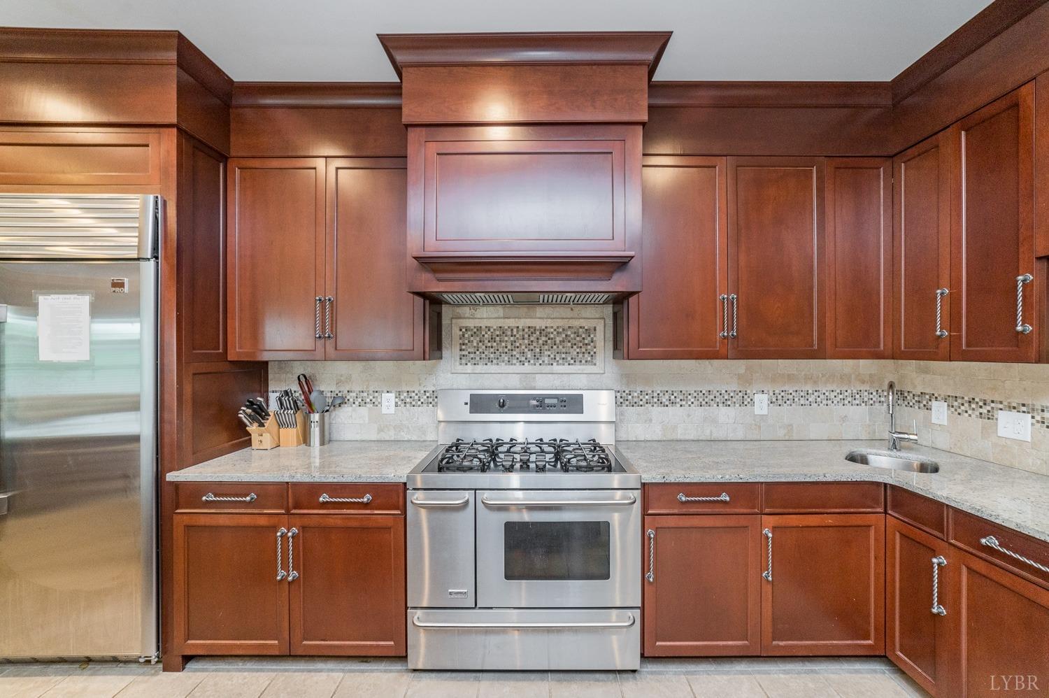 7821 Bellevue Road Goode, VA 24556 - Photo 48 of 78 a kitchen with stainless steel appliances granite countertop a stove and a sink