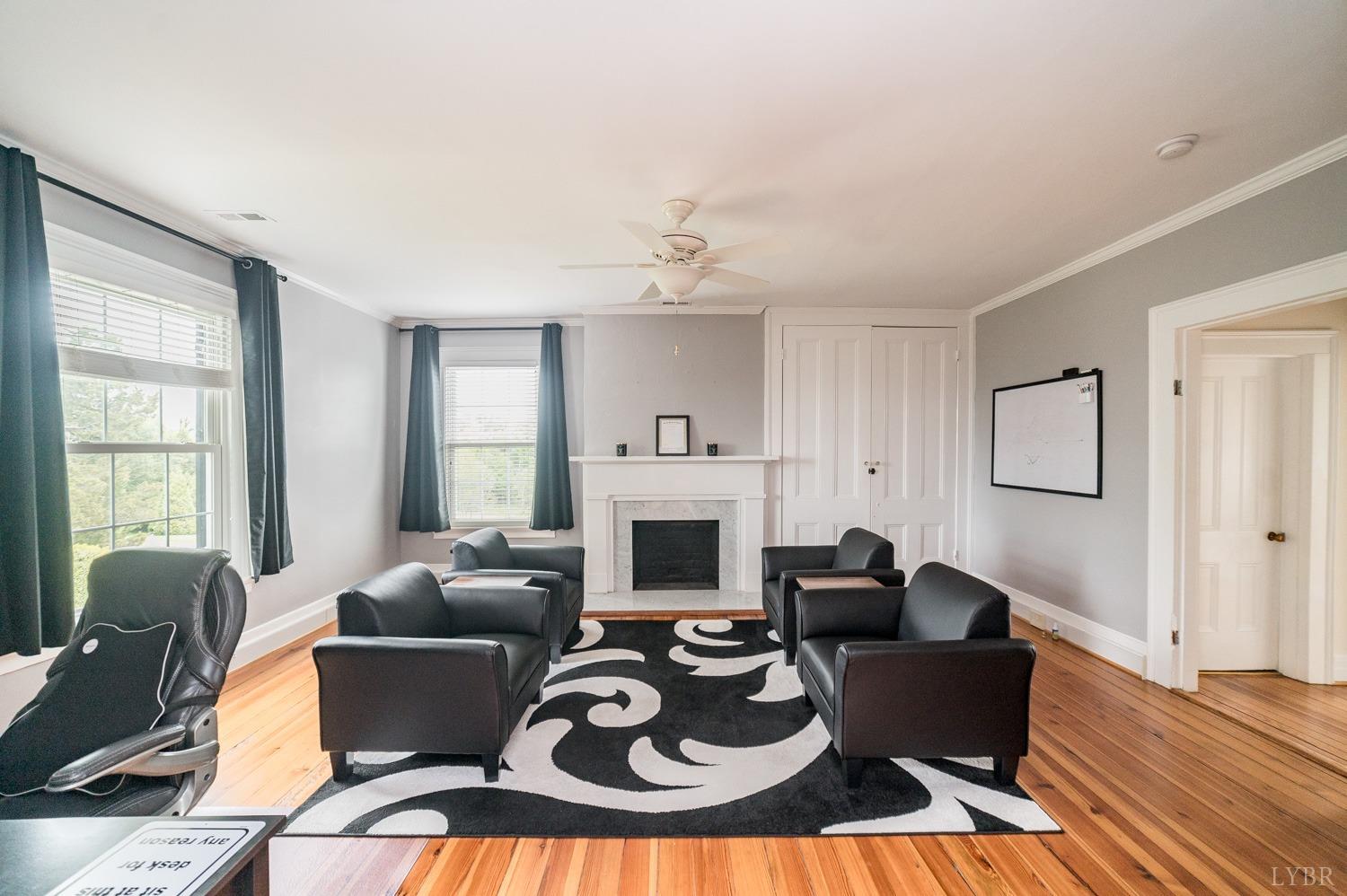 7821 Bellevue Road Goode, VA 24556 - Photo 64 of 78 a living room with furniture a fireplace and a floor to ceiling window