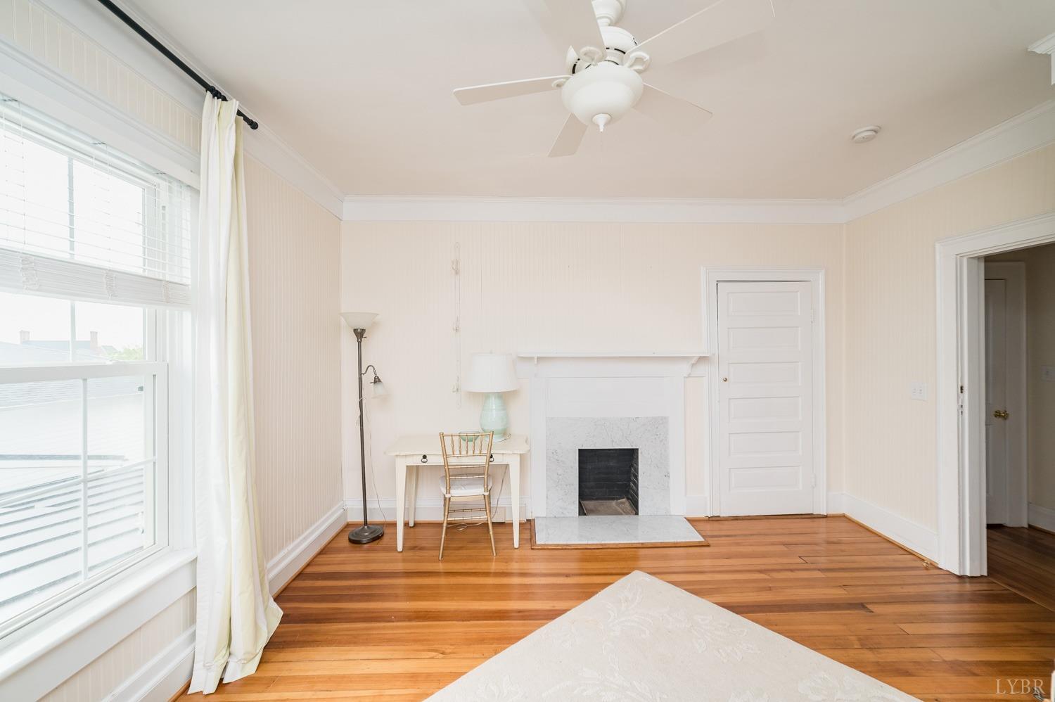 7821 Bellevue Road Goode, VA 24556 - Photo 67 of 78 a view of an empty room with wooden floor fridge and a window