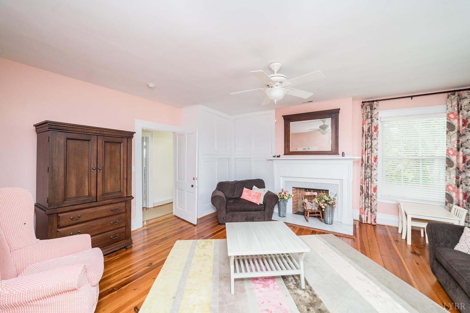 7821 Bellevue Road Goode, VA 24556 - Photo 68 of 78 a bedroom with furniture and a fireplace