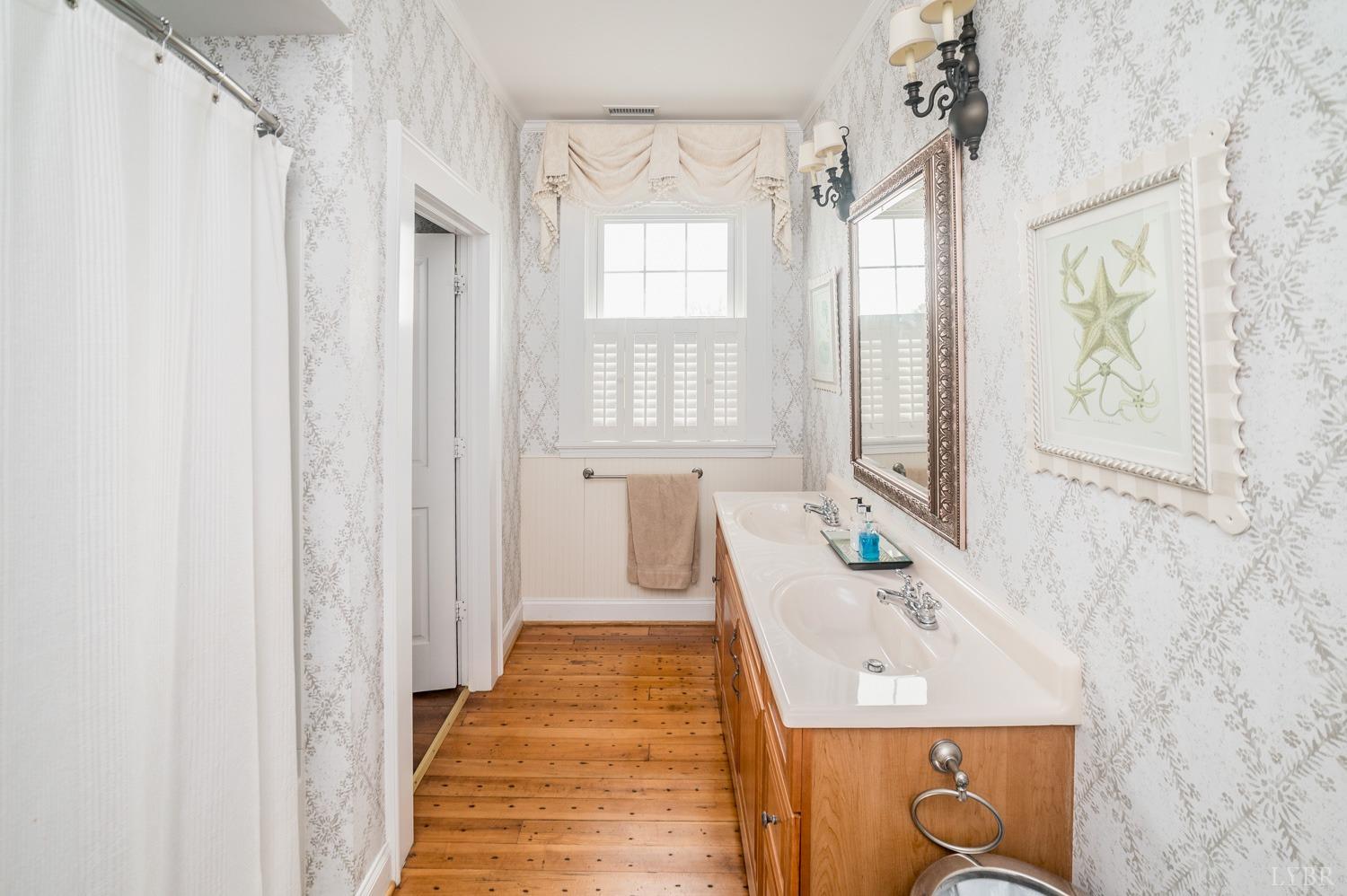 7821 Bellevue Road Goode, VA 24556 - Photo 73 of 78 a en suite bathroom with a sink a window and a shower