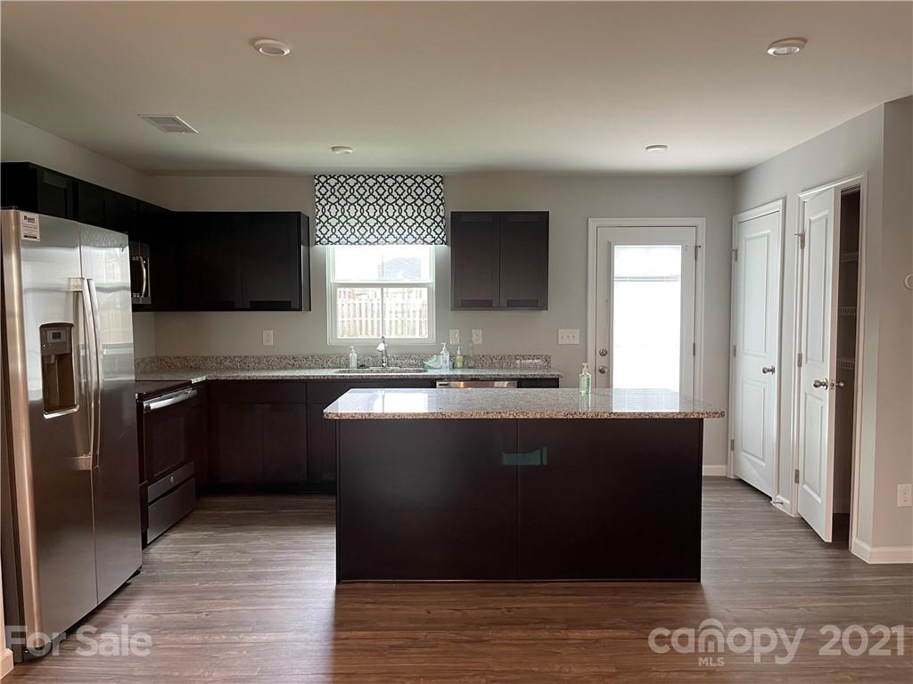 155 Beacons Field Road Columbia, SC 29209 - Photo 3 of 4 a kitchen with granite countertop a refrigerator and a stove top oven
