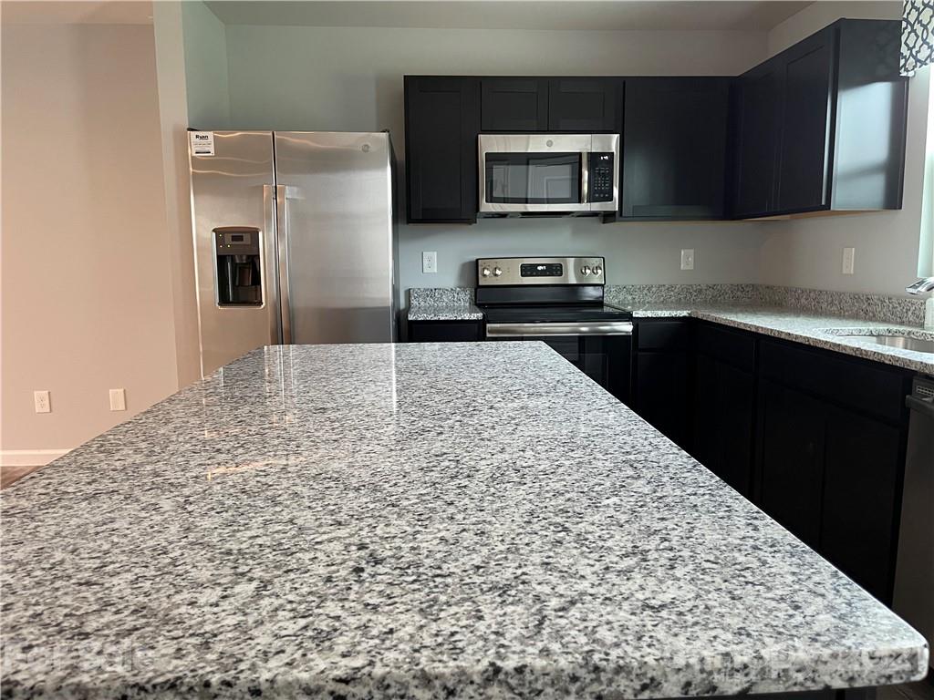 155 Beacons Field Road Columbia, SC 29209 - Photo 4 of 4 a kitchen with a refrigerator and a stove top oven