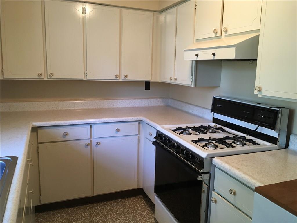 135 Economy Grade Road Coraopolis, PA 15108 - Photo 8 of 21 Solid wood cabinetry, stainless steel sink, gas stove, dishwasher and microwave oven.
