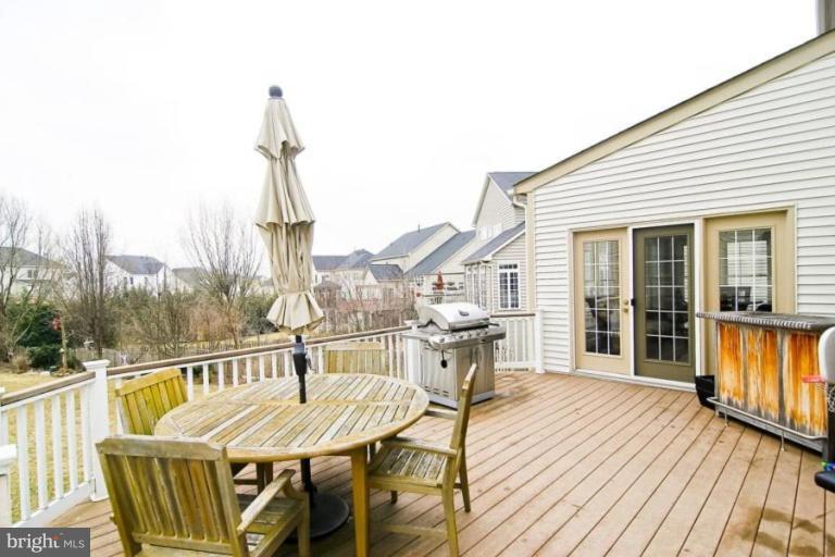 18506 Thundercloud Road Boyds, MD 20841 - Photo 7 of 17 a view of a balcony with chair and wooden floor