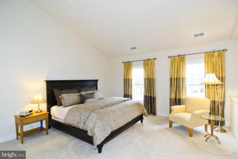 18506 Thundercloud Road Boyds, MD 20841 - Photo 8 of 17 a bedroom with a bed and a couch next to a window