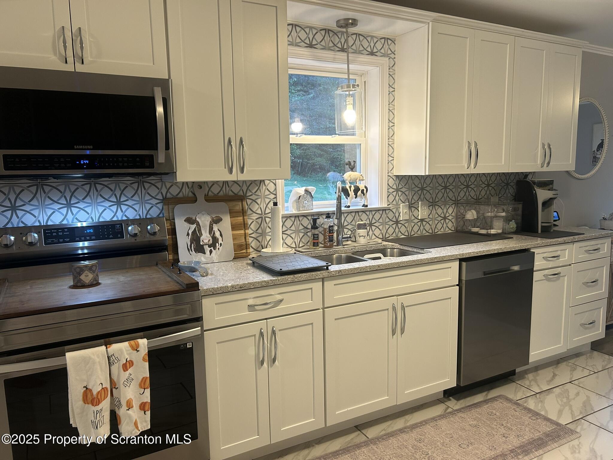 44 Franks Old Road Pleasant Mount, PA 18453 - Photo 12 of 37 a kitchen with stainless steel appliances granite countertop a sink and a stove