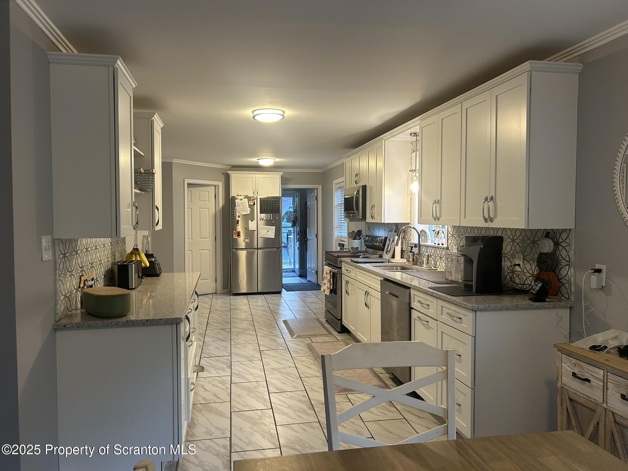 44 Franks Old Road Pleasant Mount, PA 18453 - Photo 14 of 37 a kitchen with a sink stainless steel appliances and cabinets