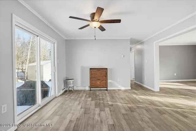 a view of a hallway and closet with wooden floor
