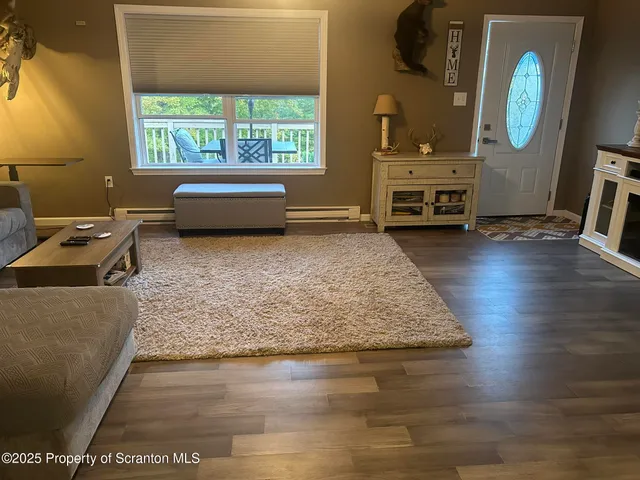 a dining room with furniture and wooden floor