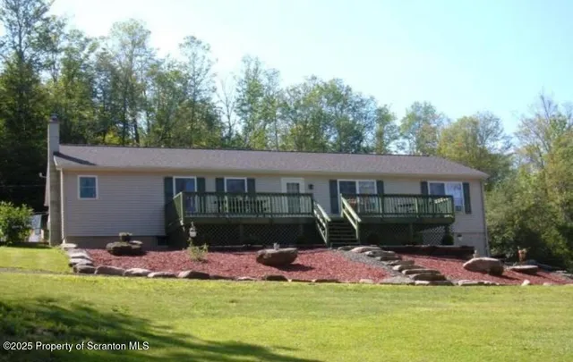 a view of a house with a yard and a patio