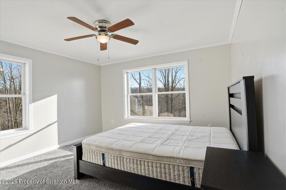 44 Franks Old Road Pleasant Mount, PA 18453 - Photo 24 of 49 a bedroom with a bed and window with a chandelier