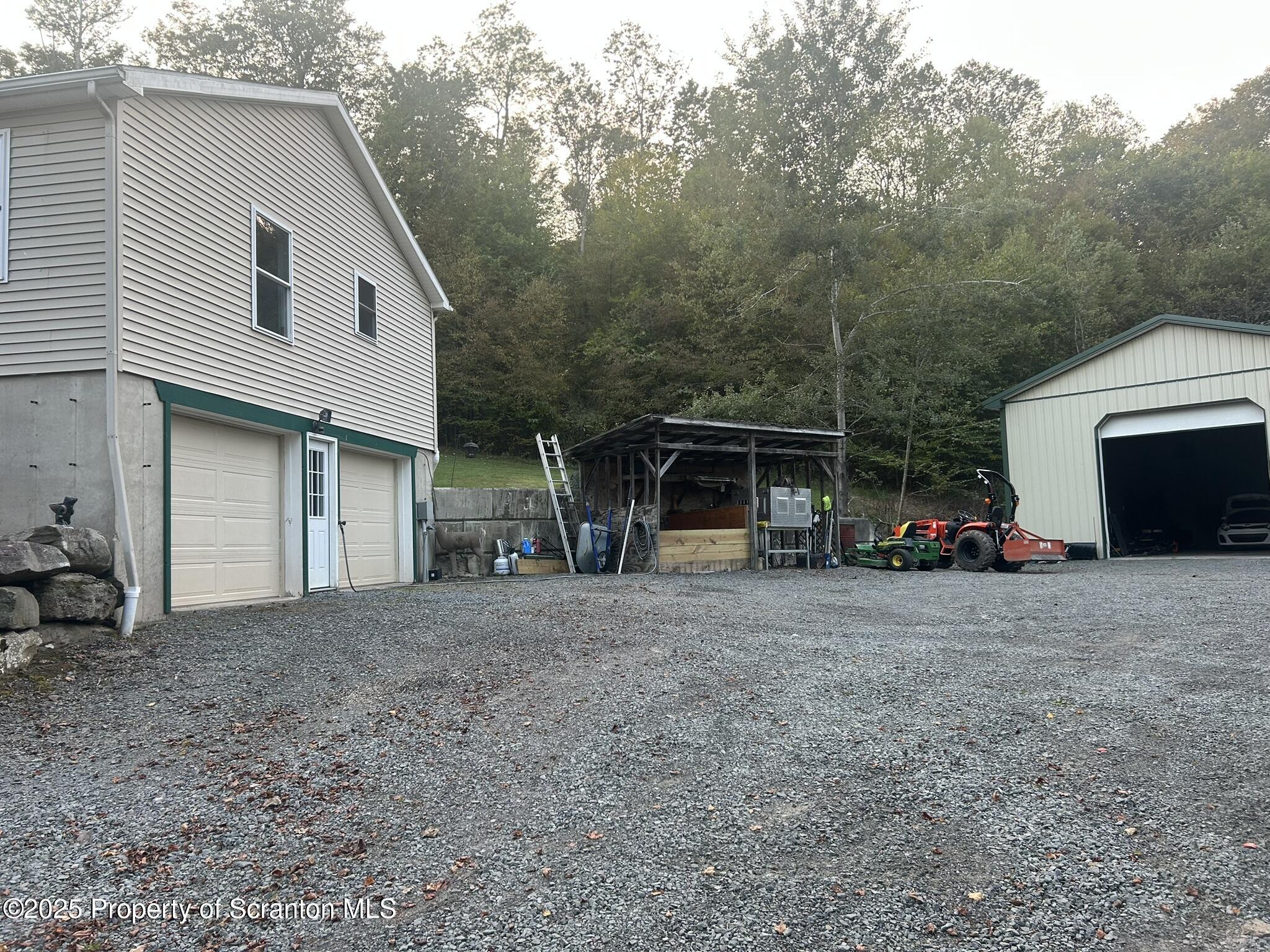 44 Franks Old Road Pleasant Mount, PA 18453 - Photo 32 of 37 a view of a house with a yard and garage