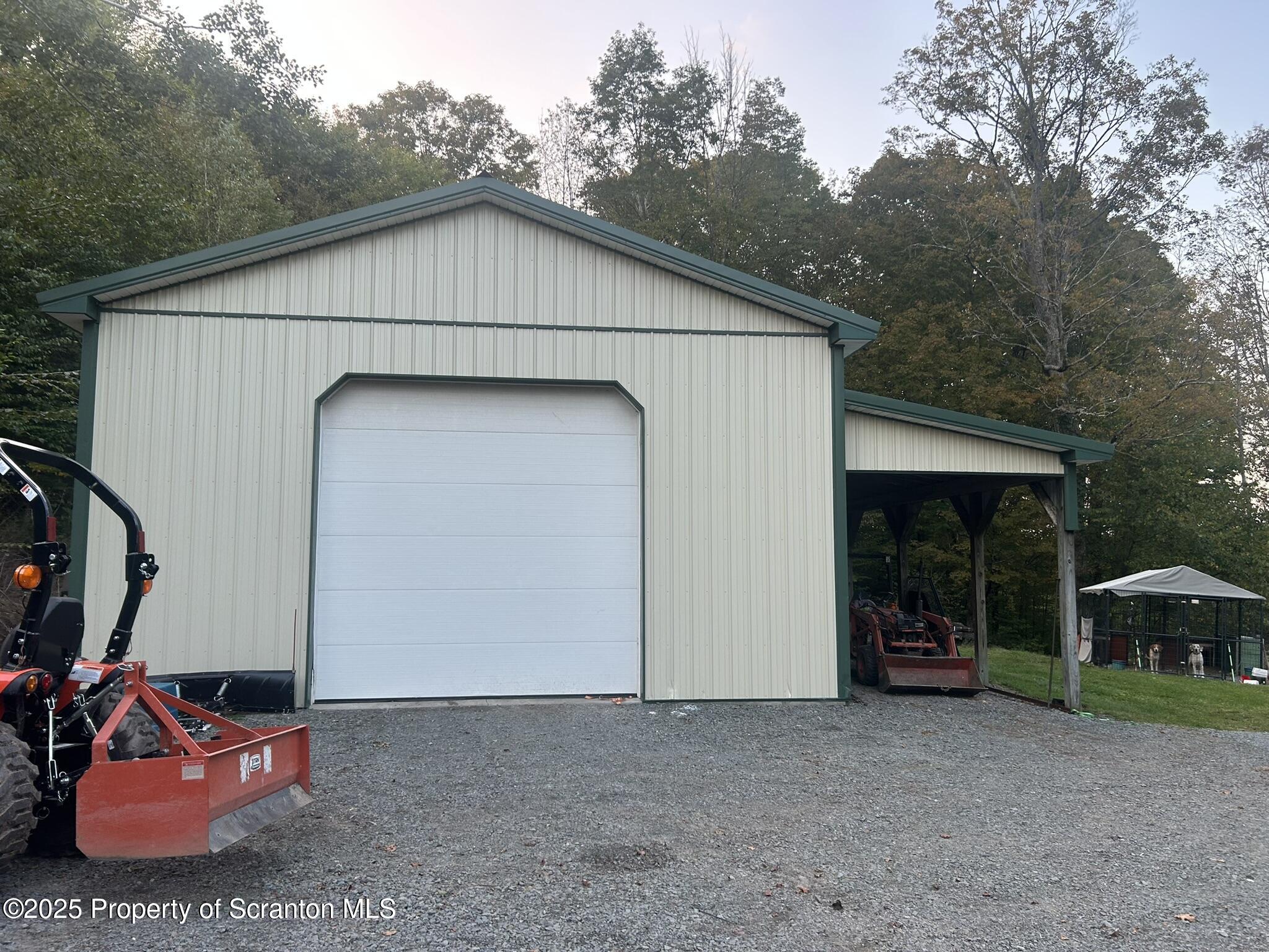 44 Franks Old Road Pleasant Mount, PA 18453 - Photo 34 of 37 a white house with tall trees in the background