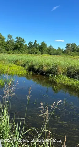 a kitchen with stainless steel appliances a stove a sink a microwave and cabinets