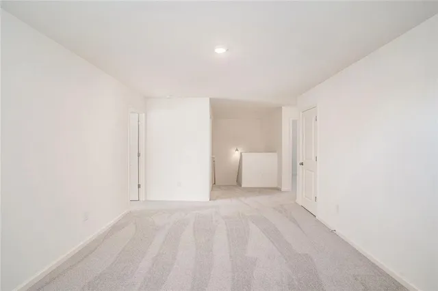 a view of a room that has a bed in it