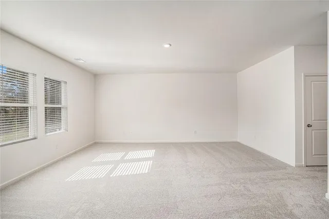 an empty room with a empty space and windows