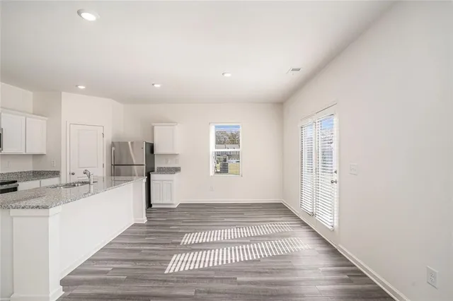 a view of a kitchen with a sink and cabinets
