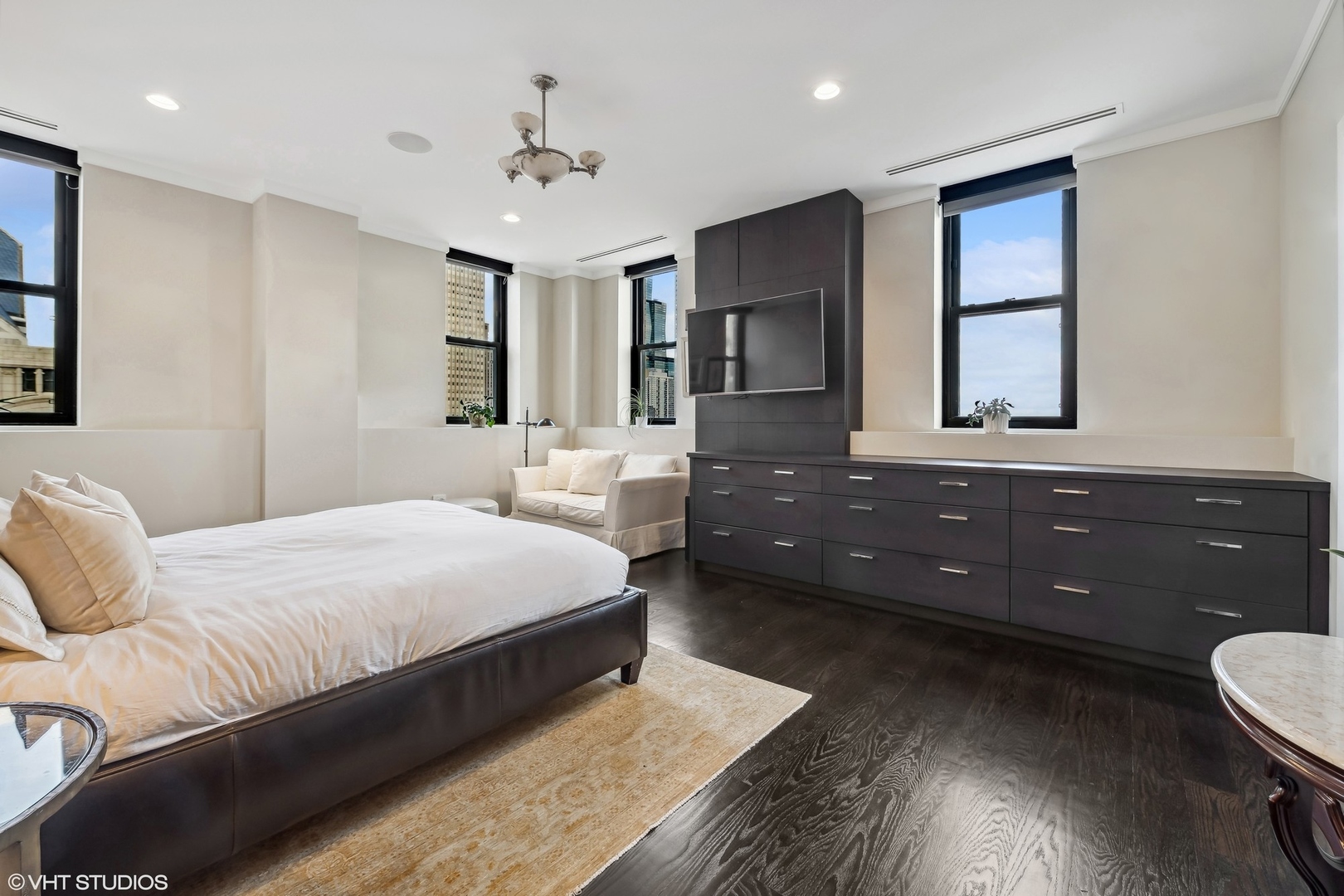 6 North Michigan Avenue, Unit 1901 Chicago, IL 60602 - Photo 36 of 54 a spacious bedroom with a bed and wooden floor