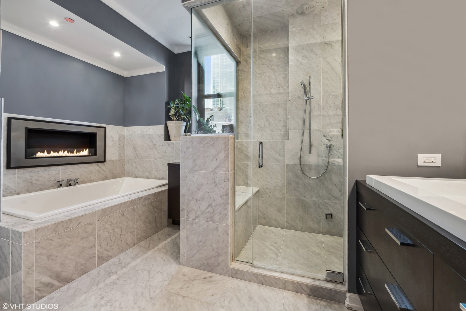 6 North Michigan Avenue, Unit 1901 Chicago, IL 60602 - Photo 37 of 54 a spacious bathroom with a tub a mirror and a shower