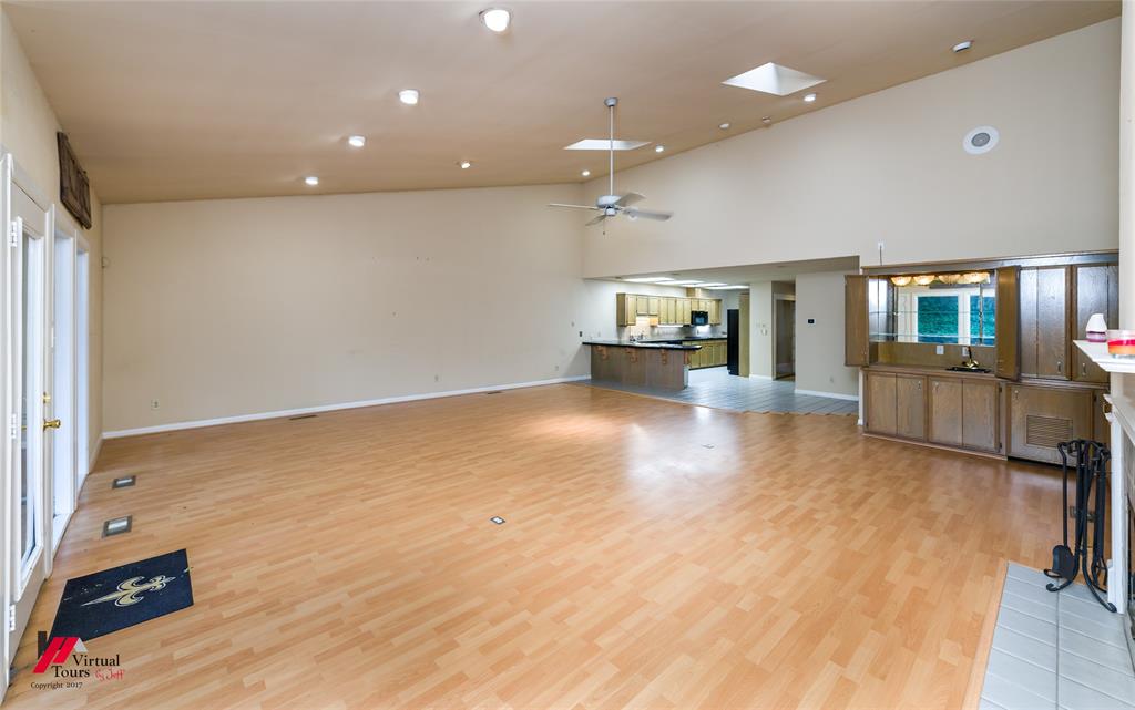 300 Pierremont Road, Unit 40 Shreveport, LA 71106 - Photo 22 of 34 Spacious living area featuring LVF flooring, vaulted ceilings, recessed lighting, and a skylights