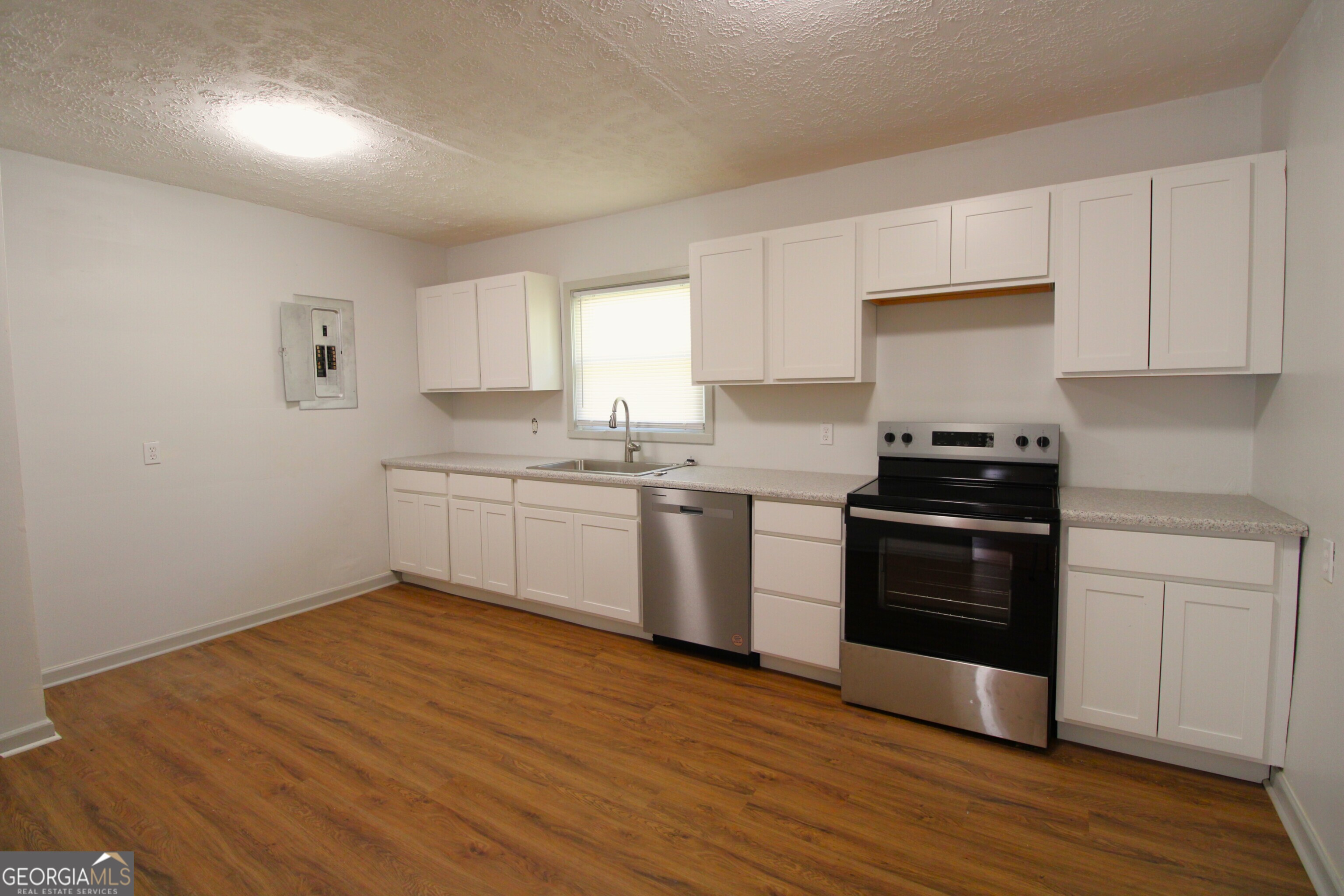3589 Irwin Way Columbus, GA 31906 - Photo 12 of 25 a kitchen with granite countertop a sink cabinets and stainless steel appliances