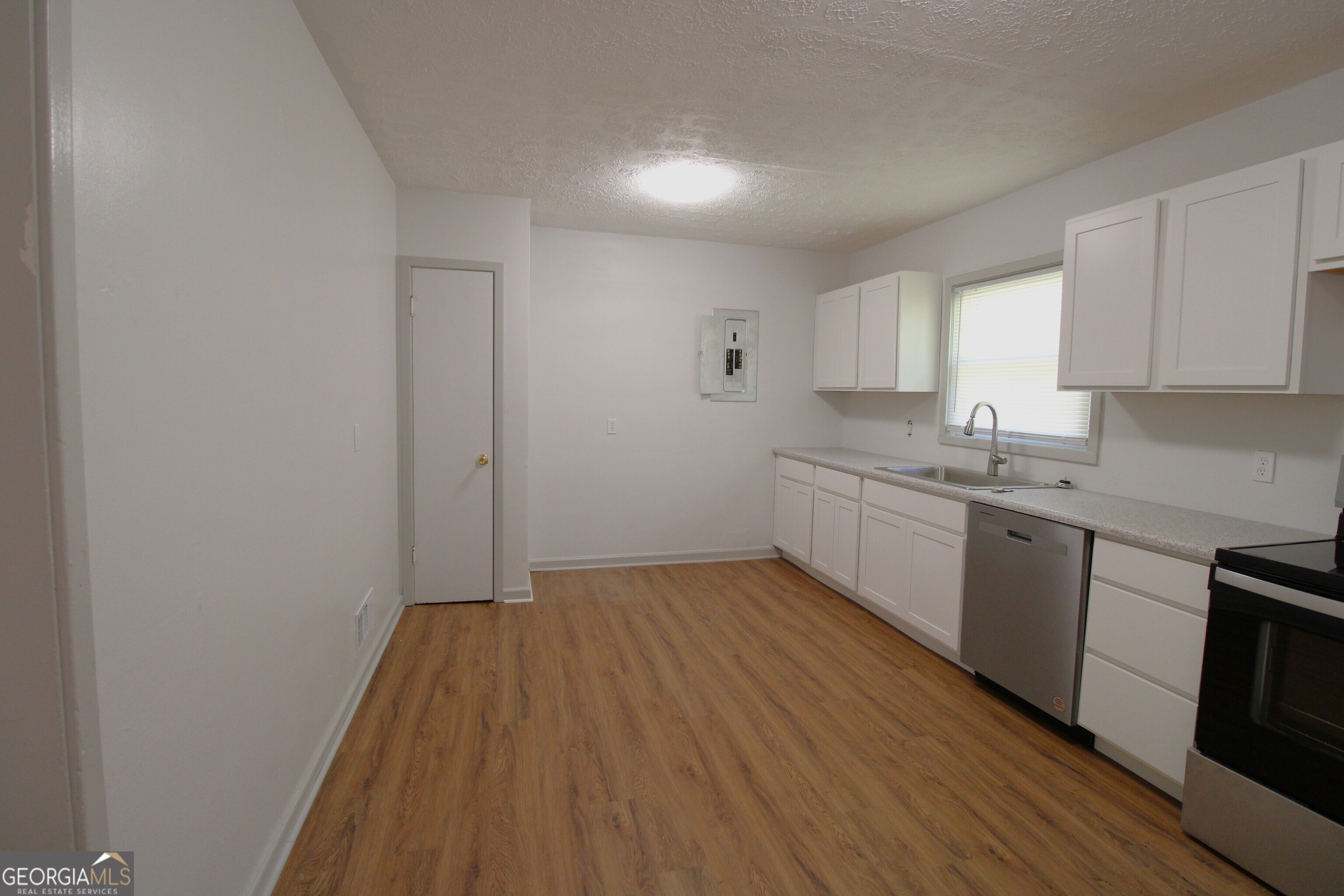 3589 Irwin Way Columbus, GA 31906 - Photo 13 of 25 a kitchen with a sink window and cabinets