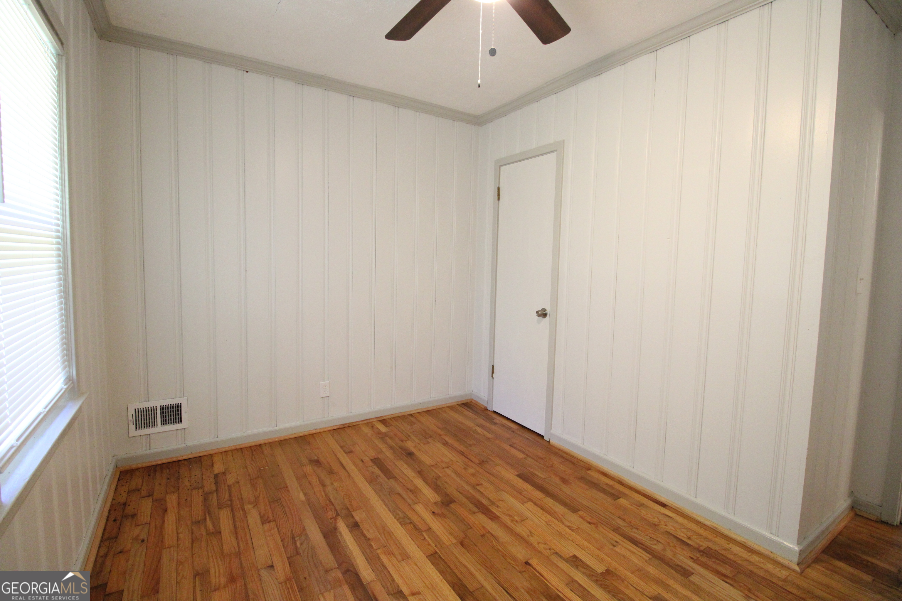 3589 Irwin Way Columbus, GA 31906 - Photo 16 of 25 an empty room with a hardwood and a ceiling fan