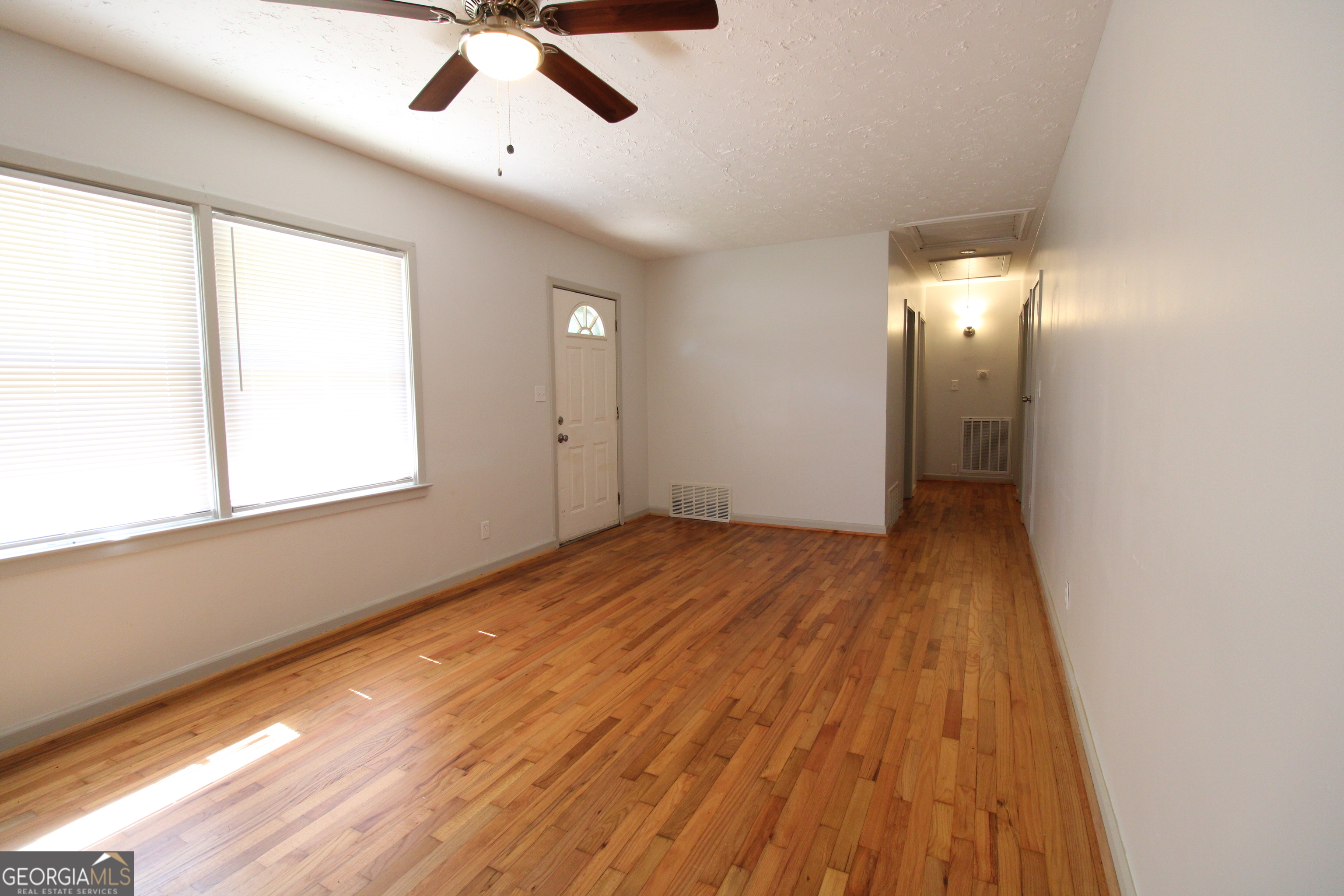 3589 Irwin Way Columbus, GA 31906 - Photo 6 of 25 a view of empty room with wooden floor and fan
