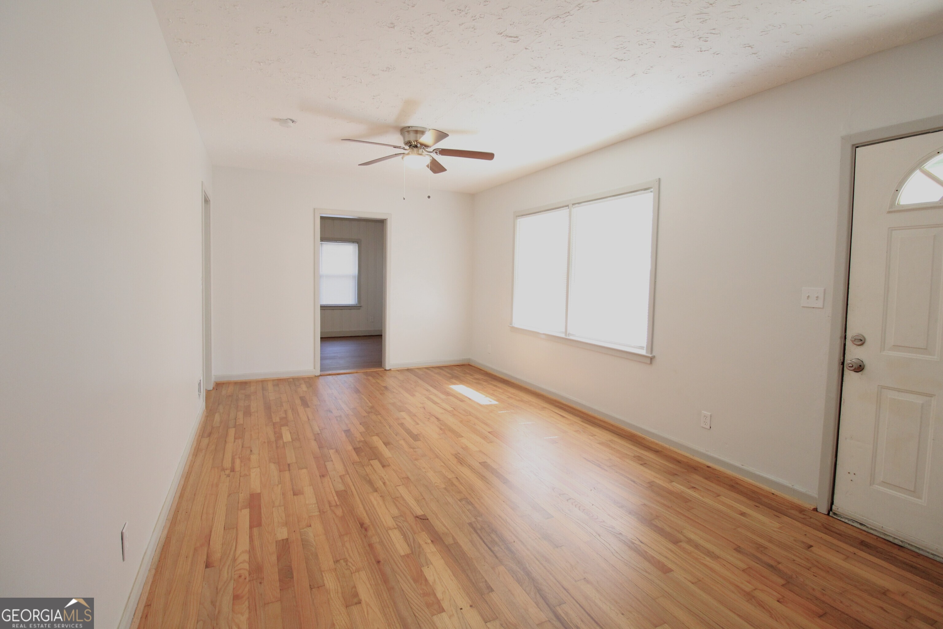3589 Irwin Way Columbus, GA 31906 - Photo 7 of 25 a view of empty room with wooden floor and fan