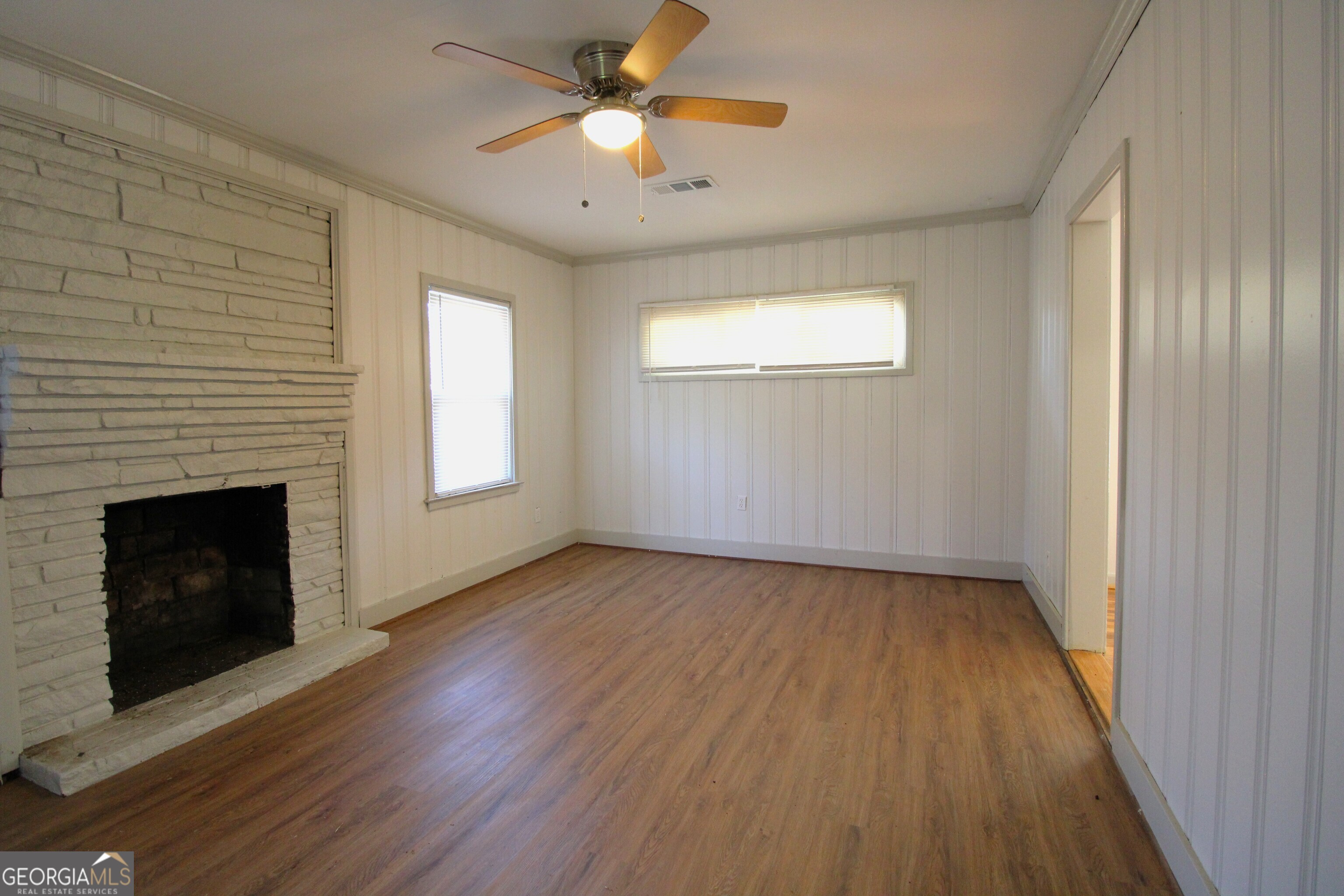 3589 Irwin Way Columbus, GA 31906 - Photo 8 of 25 an empty room with wooden floor fireplace and window
