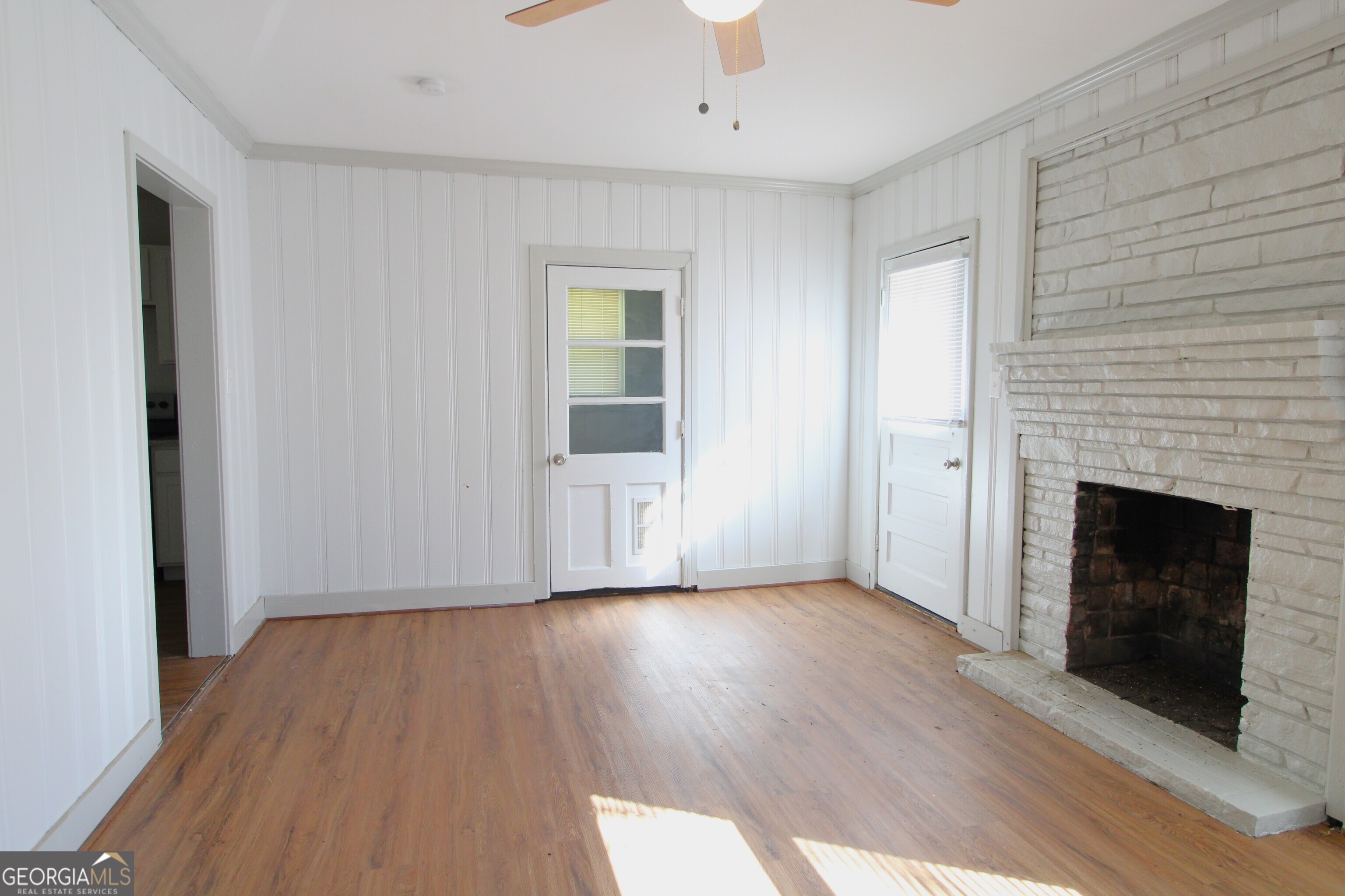 3589 Irwin Way Columbus, GA 31906 - Photo 9 of 25 a view of an empty room with wooden floor and a fireplace